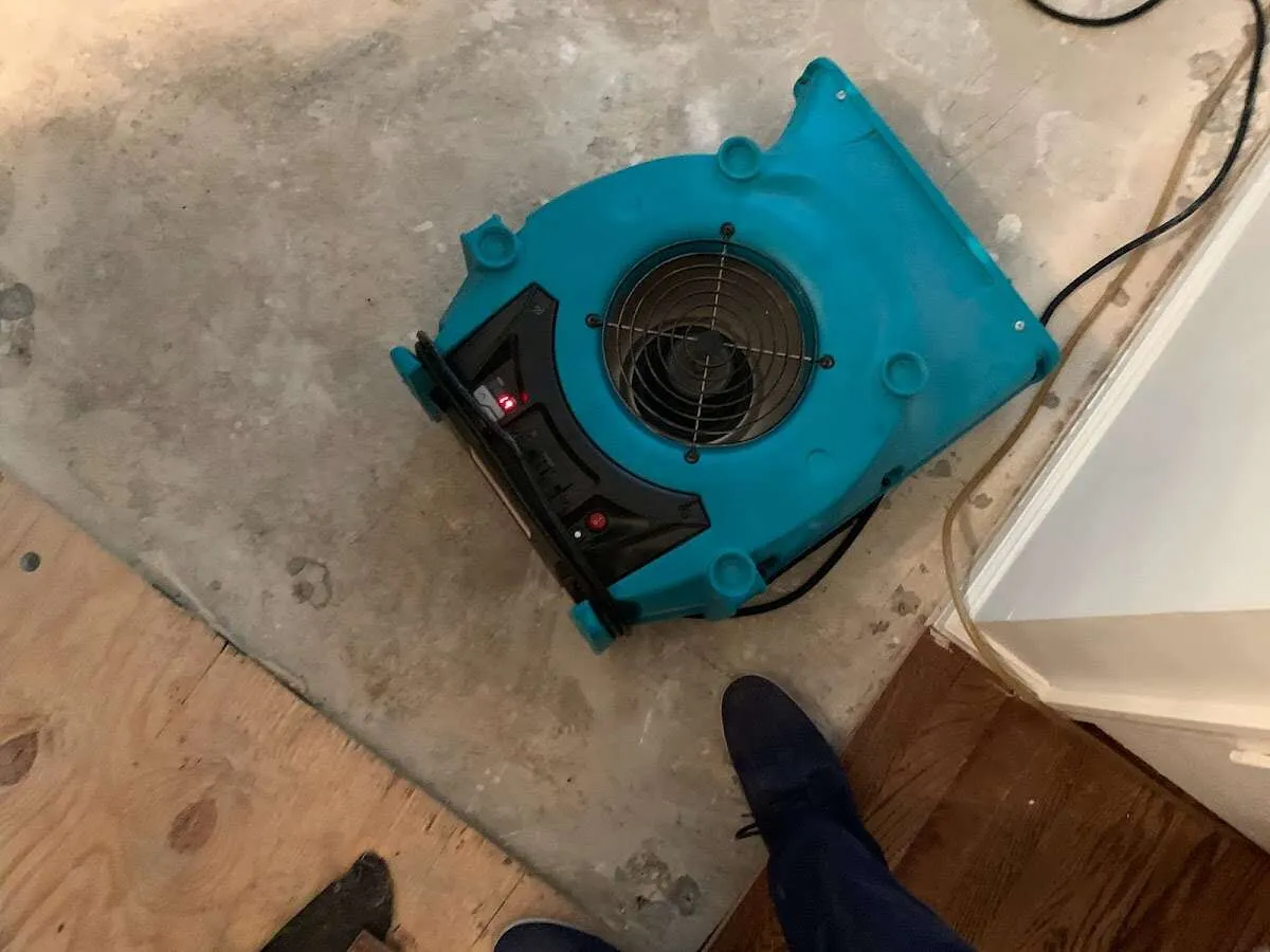 Air mover drying subfloor during Commercial Water Damage Restoration in Palmetto Bay
